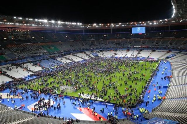 Spectators invade the pitch of the Stade de France stadium after the international friendly soccer France against Germany